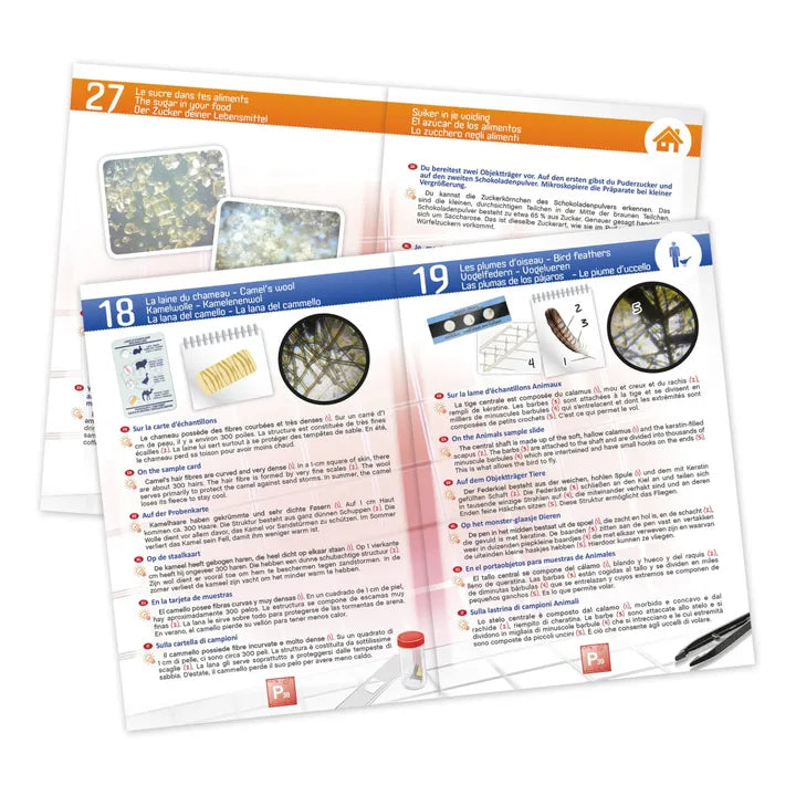 Detalhe de algumas das fichas de experiências incluídas no kit Buki Microscópio, mostrando instruções e ilustrações em várias línguas.