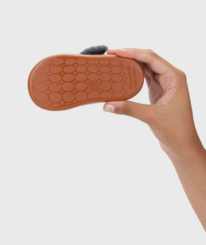 Vista da sola antiderrapante das pantufas barefoot, garantindo aderência extra e segurança para os primeiros passos.
