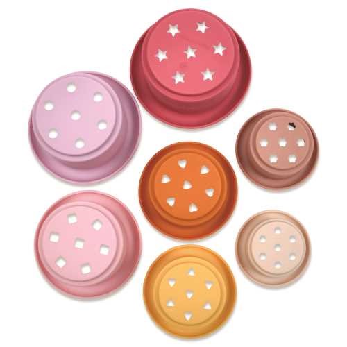 Vista detalhada da base dos vasos de silicone Tiny Twinkle, mostrando os diferentes padrões de perfurações para brincar na água.