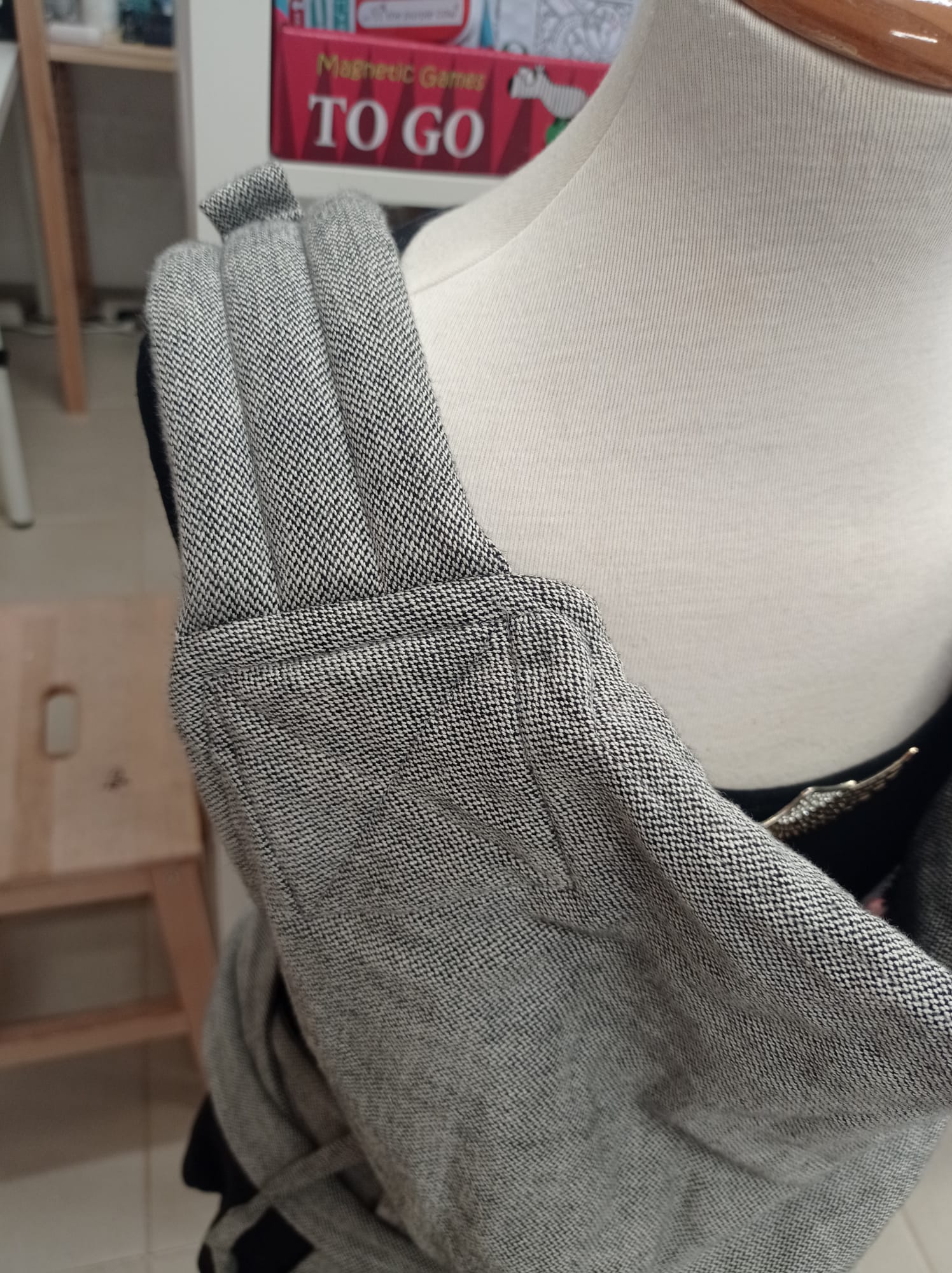 Detalhe do porta-bebés cinzento em tecido de sarja, mostrando a qualidade e o design do produto Gotu para aluguer.