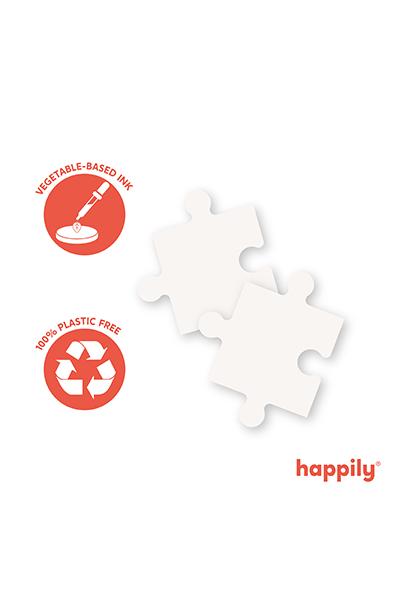 Duas peças de puzzle brancas da Happily, com ícones de tinta de origem vegetal e "100% plastic free" / reciclado.