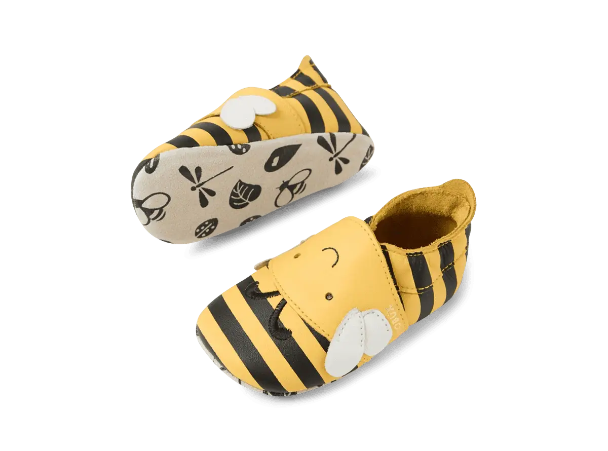 Par de sapatos Bobux Bugbee Abelha, vista angular, destacando o design de abelha e as solas flexíveis com padrão.