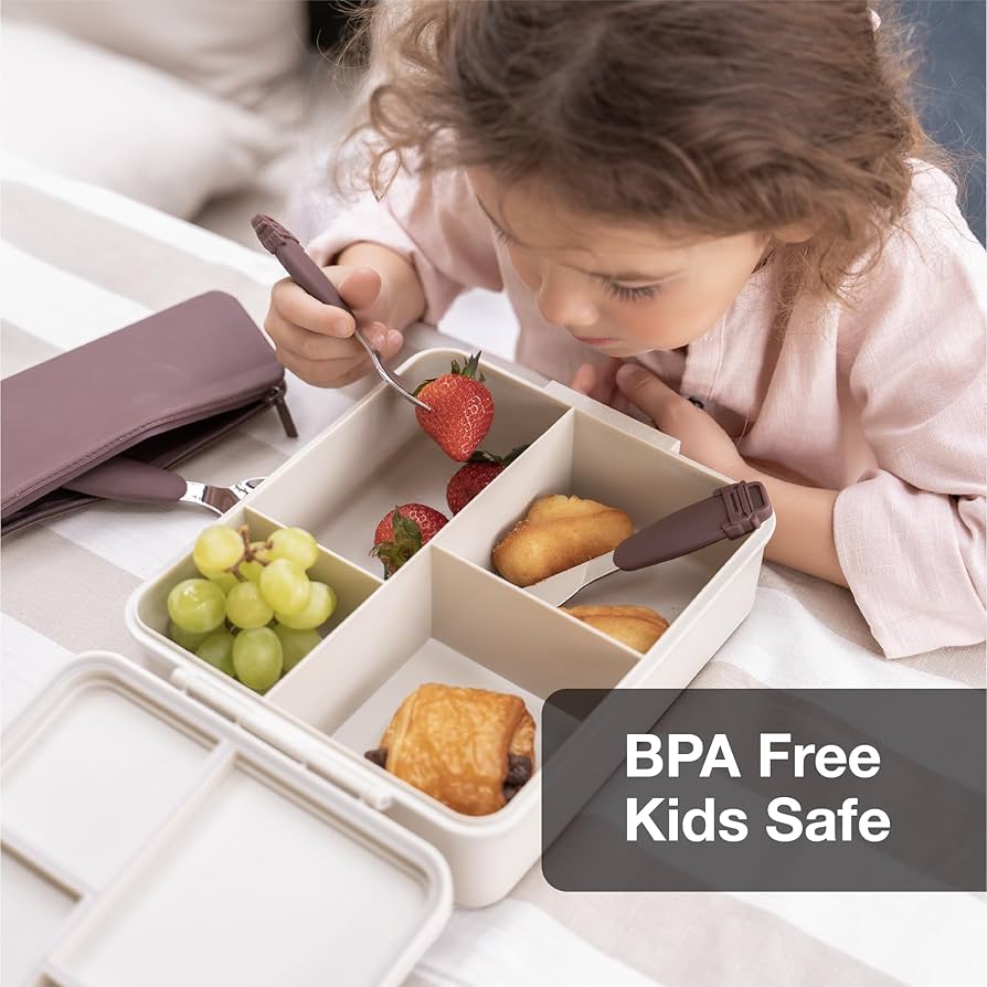 Criança a comer de uma Lancheira Citron Bailarina aberta, mostrando os compartimentos com fruta e lanches.