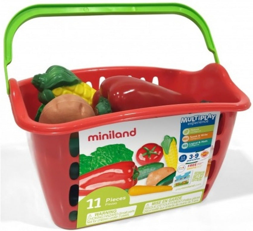 Cesto de legumes Miniland vermelho e verde, contendo vários legumes de brincar, com o logótipo da marca e informações sobre o jogo simbólico.