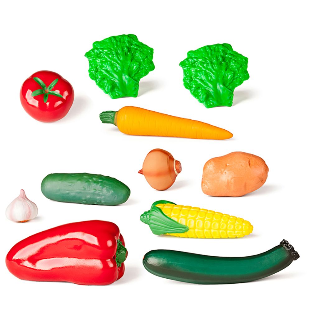 Conjunto de 11 legumes de brincar Miniland, incluindo tomate, alface, cenoura, cebola, batata, alho, pepino, pimento, milho e curgete, dispostos sobre um fundo branco.