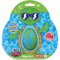 Embalagem da bomba de banho ZIMPLIKIDS Tartaruga 100gr, mostrando uma tartaruga verde com óculos de sol e a bomba azul e verde no centro, com indicação "Strawberry Scented".