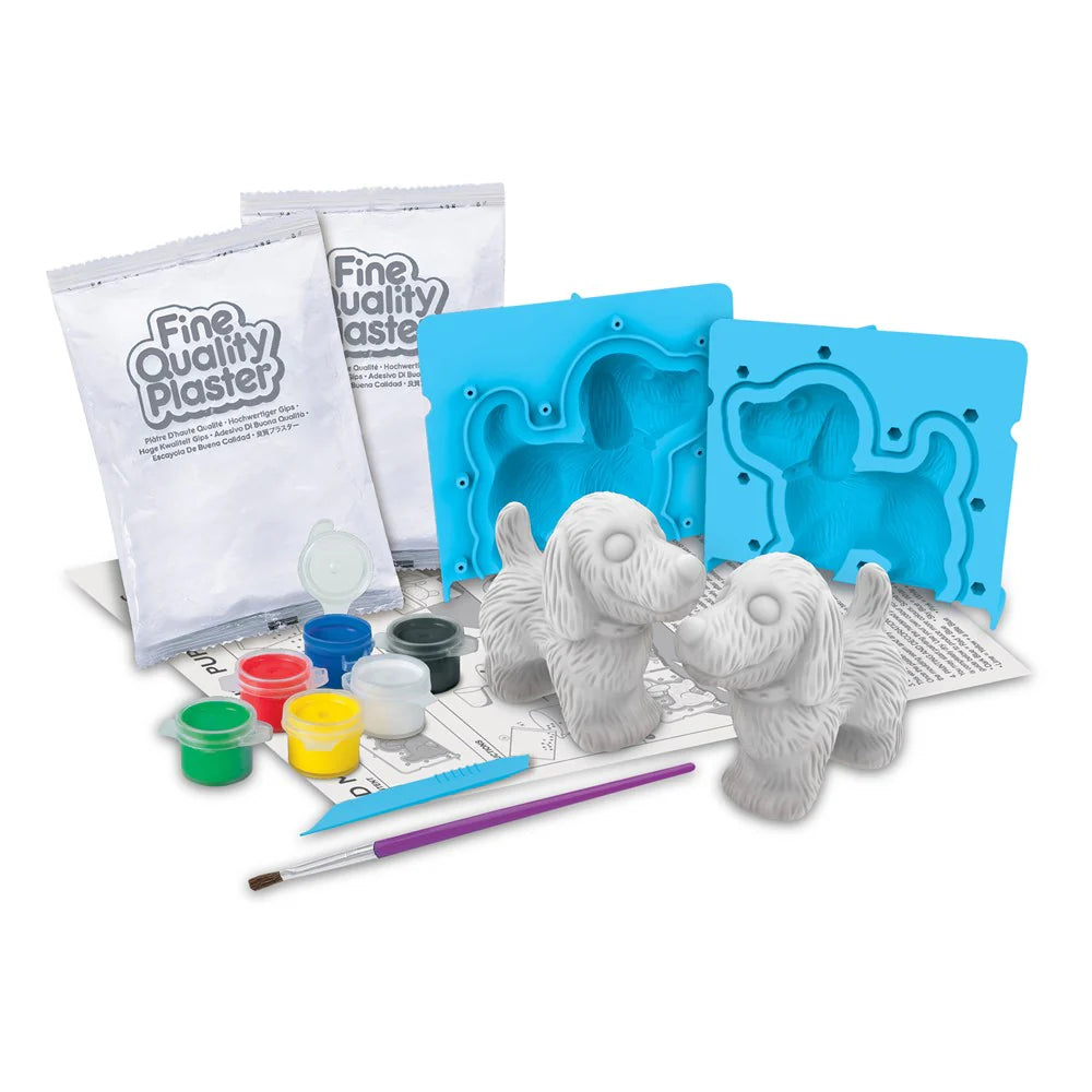 Componentes do kit "3D Cãezinhos" da 4M: dois sacos de gesso, moldes de silicone azuis, tintas coloridas, pincel e duas figuras de cão em gesso cru.