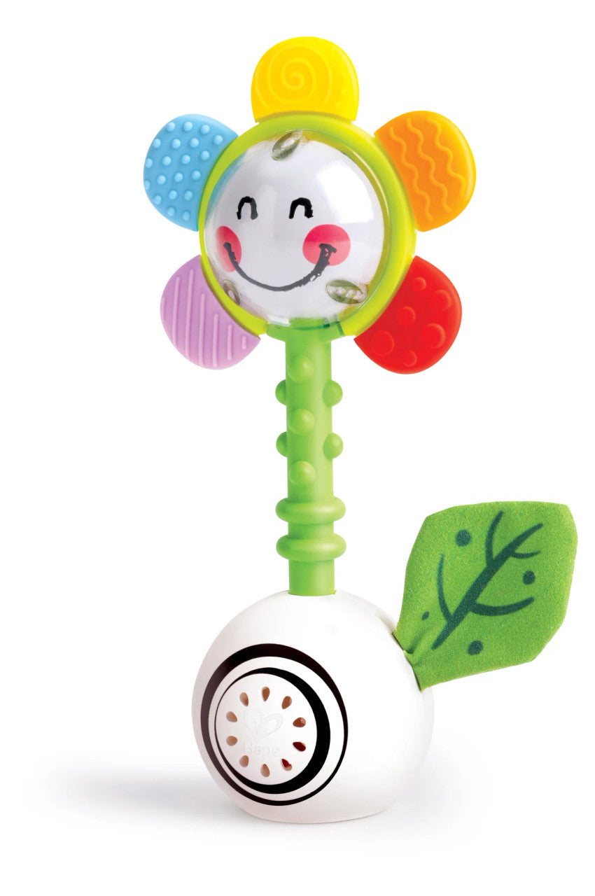 Hape Guizo com luz e formas em fundo branco, mostrando o design completo da flor sorridente e base.