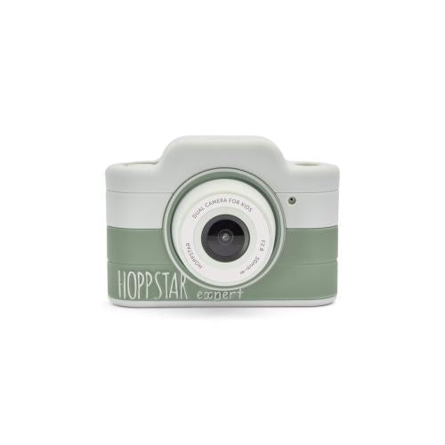 Vista frontal da Hoppstar Máquina Fotográfica Digital Expert em tons de verde e branco, com a lente central e o logótipo visíveis.