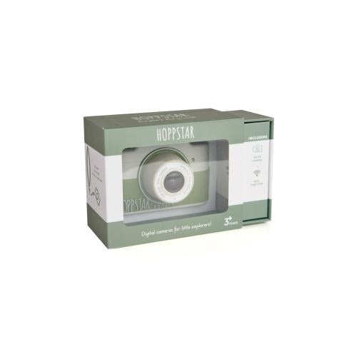 Hoppstar Máquina Fotográfica Digital Expert na sua embalagem de retalho verde, com a câmara visível através da caixa.