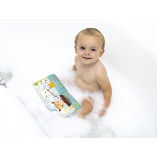 Um bebé sorridente sentado na banheira, com o Ludi Livro de pintar no banho aberto ao seu lado na água.
