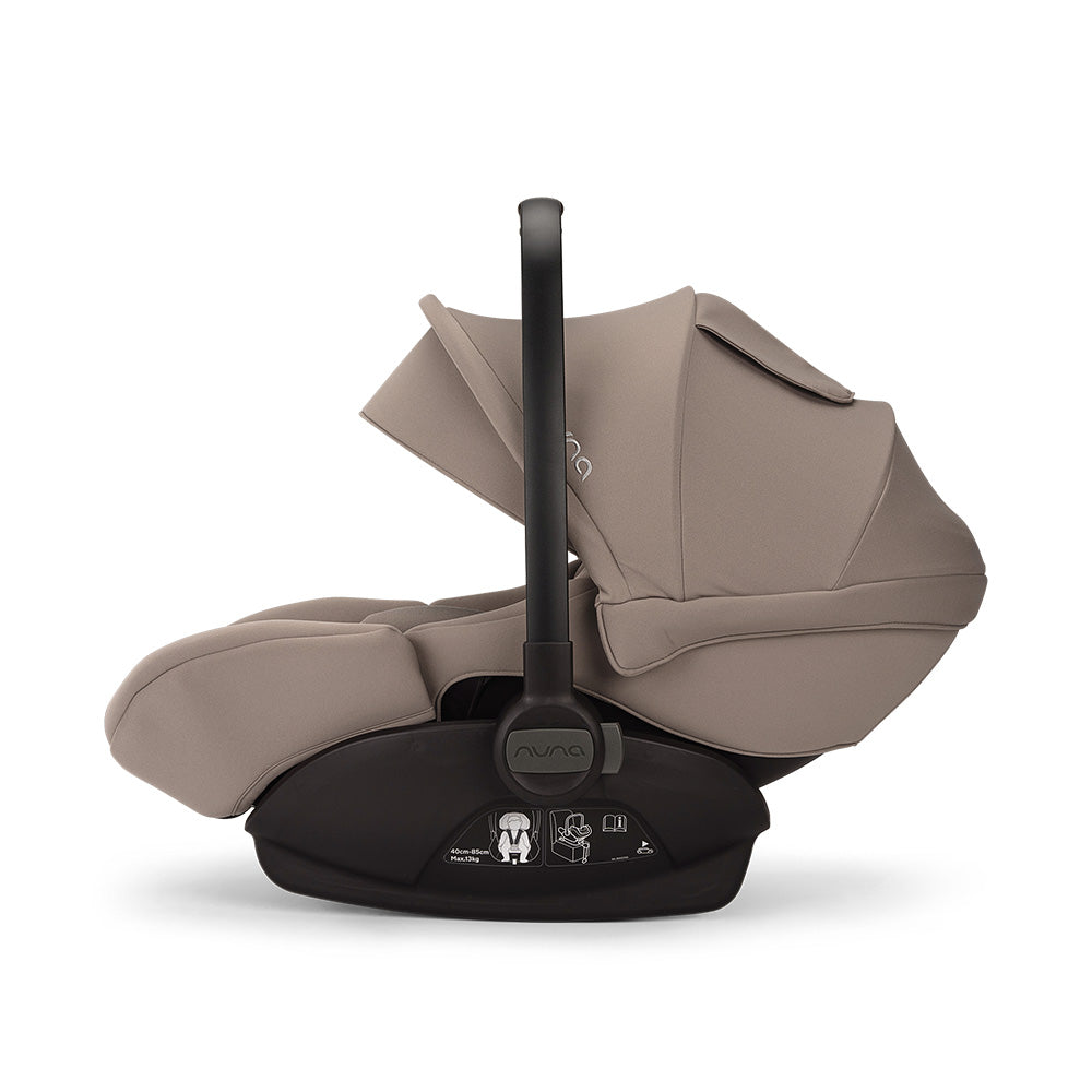 Vista lateral de uma cadeira auto ARRA em bege, instalada na base Isofix, com capota levantada.
