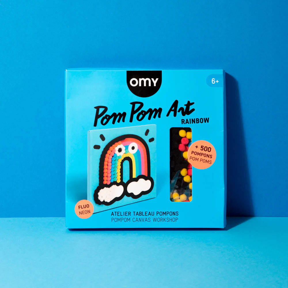 Caixa do OMY Kit Pintura com pompons Arco Iris em destaque, com a imagem do arco-íris e a indicação de "+ 500 POMPONS".
