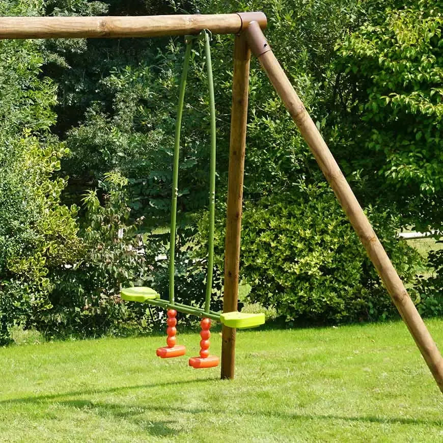 Baloiço face-a-face instalado numa estrutura de madeira num jardim, com assentos em plástico e apoios para os pés em vermelho.