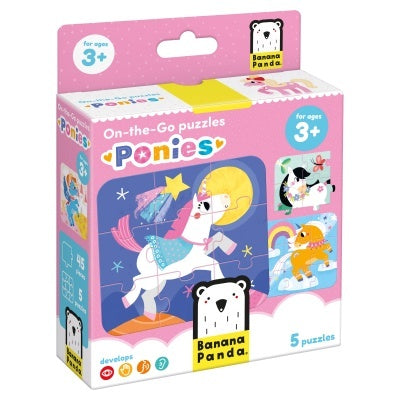 Caixa rosa dos Jogos de Viagem "Ponies" da Banana Panda, mostrando um puzzle de unicórnio noturno e a indicação de 5 puzzles para idades a partir dos 3 anos.