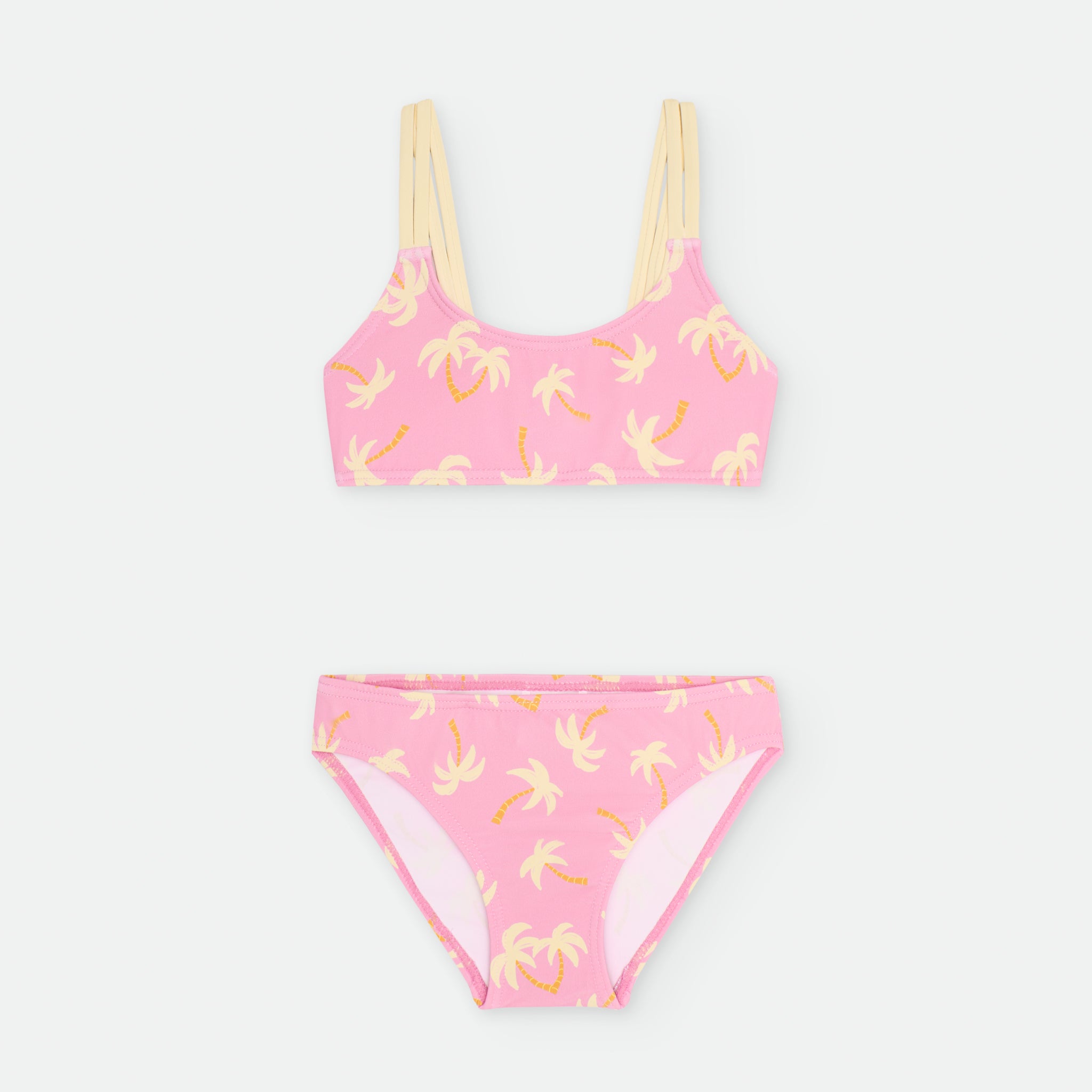 Biquíni de praia para menina da marca Waterlemon com estampado de palmeiras em fundo rosa.