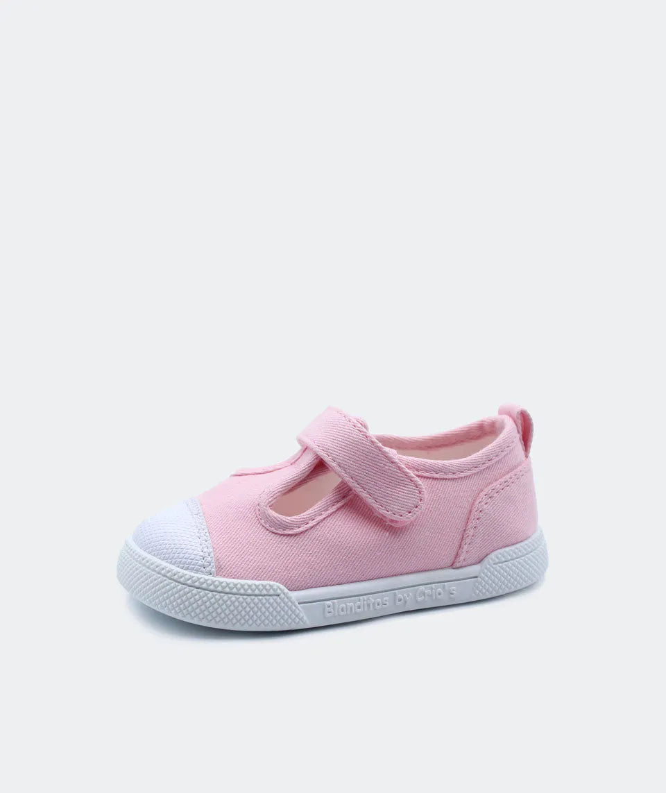 Calçado barefoot Blanditos by Crio's em lona rosa, com sola branca e fecho em velcro. Confortável e ergonómico, ideal para o desenvolvimento infantil.
