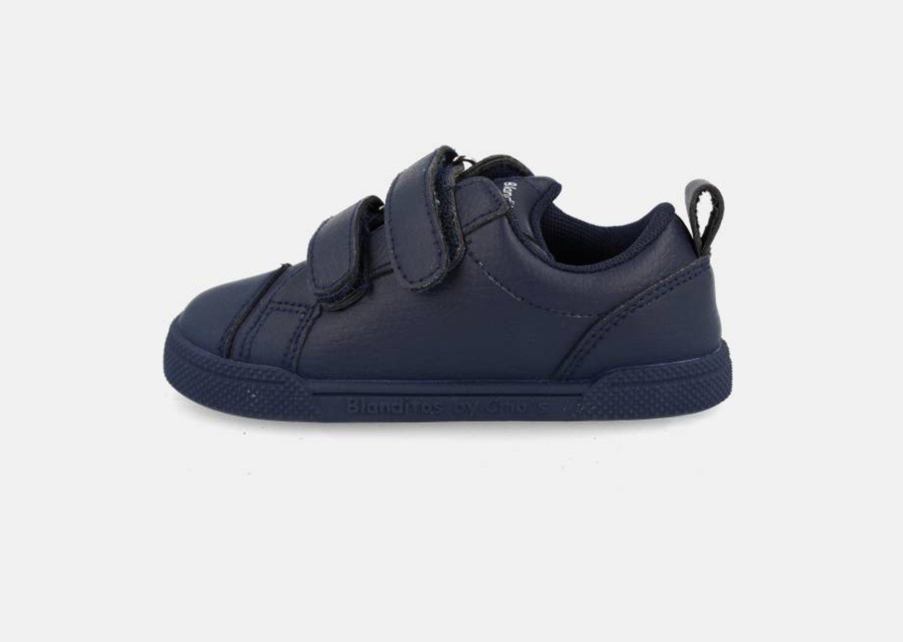 Vista lateral da sapatilha vegana Zeus marinho, mostrando a sola fina e flexível e o fecho de velcro.