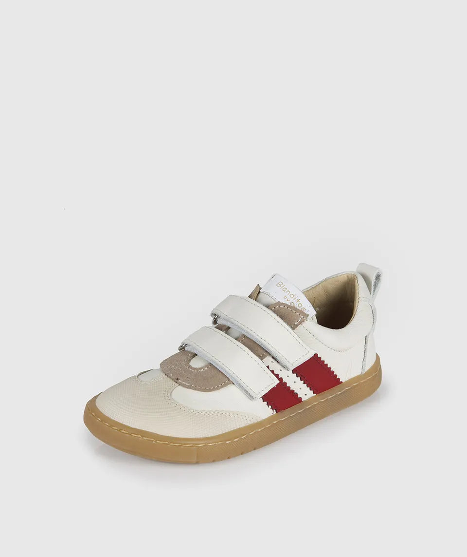 Vista lateral das sapatilhas Blanditos Marea Duero (bege/vermelho), calçado barefoot infantil com base bege, risca lateral vermelha e velcro branco. Calçado Respeitador.