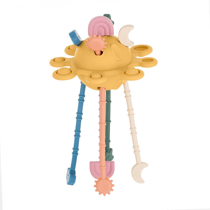 Brinquedo sensorial em silicone amarelo em forma de planeta com apêndices coloridos e cordas para puxar.