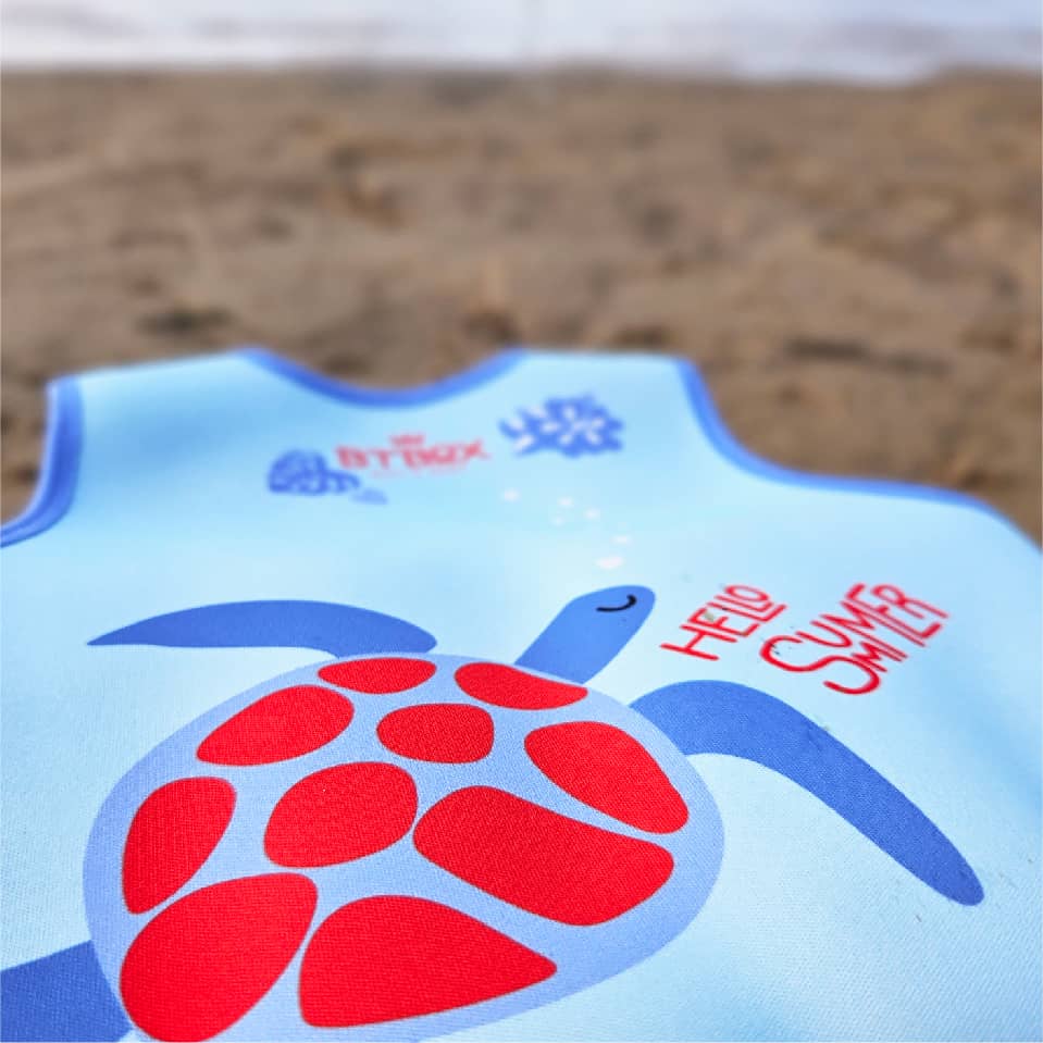 Detalhe da estampa de tartaruga e "Hello Summer" no verso do colete de natação BtBox.