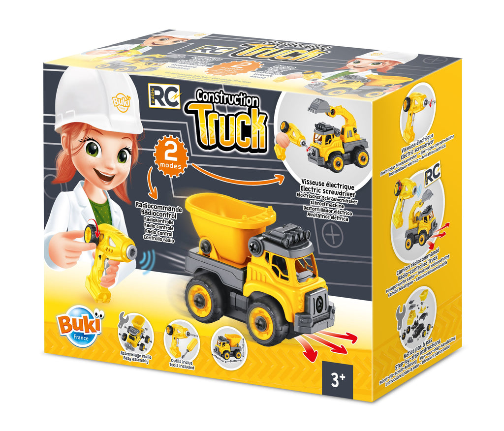 Caixa do brinquedo Buki RC Construction Truck, mostrando uma menina a usar a chave de fendas elétrica e o camião amarelo e cinzento com a inscrição "2 modes" e "3+".