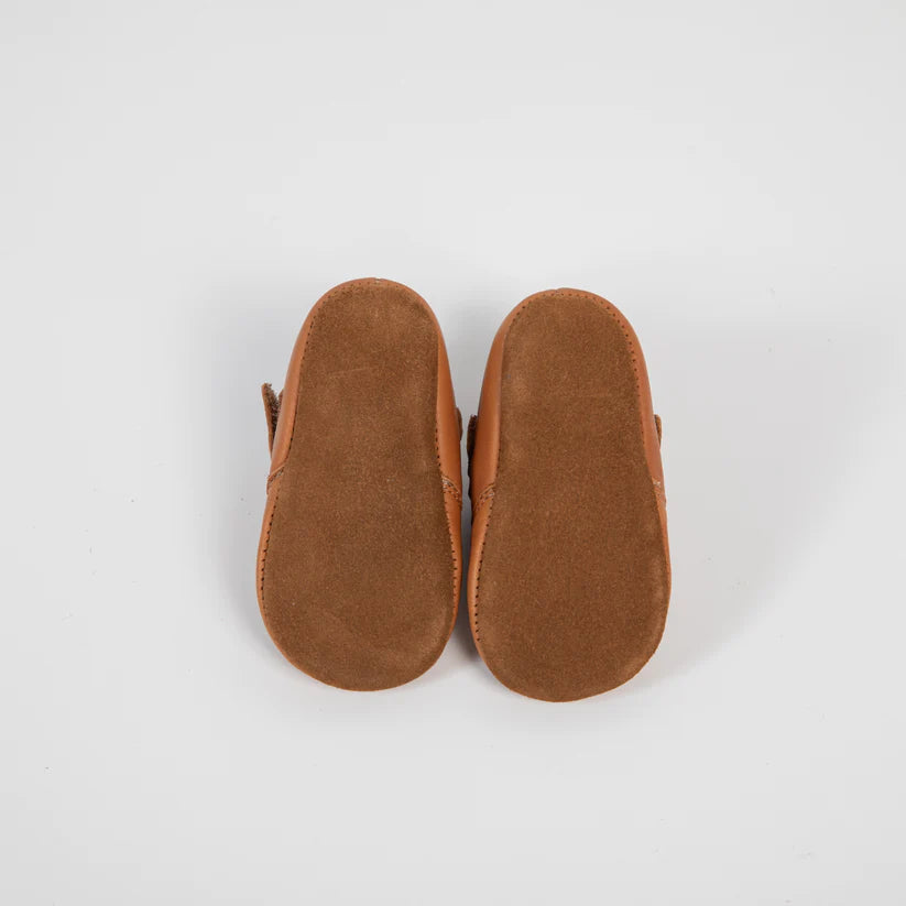 Vista inferior (sola) dos sapatinhos Barefoot Girafinha camel, evidenciando a sola de camurça macia e flexível, ideal para primeiros passos.