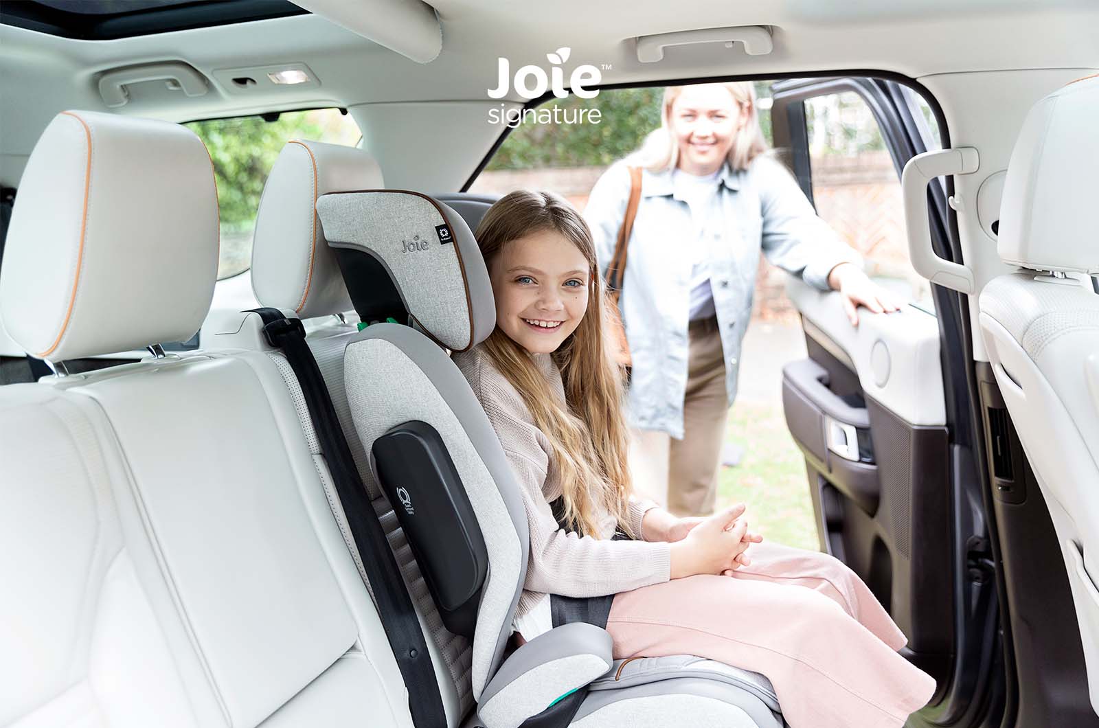 Cadeira auto Joie i-Traver Signature na cor preta/antracite, vista frontal, destacando o tecido premium e os apoios de braços acolchoados.