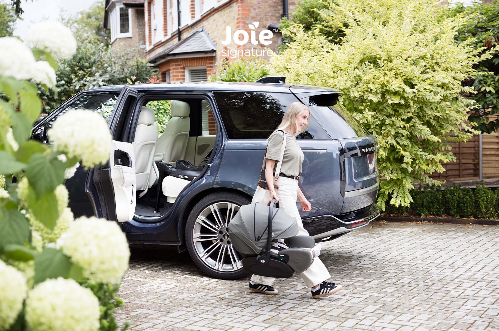 Cadeira auto ovo Joie i-Level Pro Signature instalada em base ISOFIX (vendida separadamente), focando na segurança i-Size e posição contra a marcha.