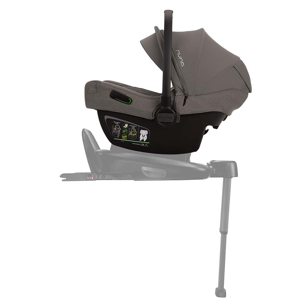 Cadeira auto ovo Nuna Pipa Next na cor cinza escura, instalada contra a marcha num carro, vista de perfil. Destaca a leveza e o design moderno.