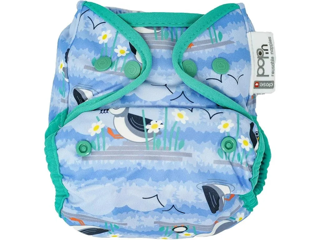 Fralda reutilizável Close Pop-in tamanho único, com estampado de papagaios-do-mar azuis e detalhes verde-água. Vista frontal.