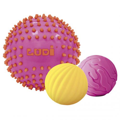 Três bolas sensoriais Ludi isoladas em tons de rosa e amarelo.