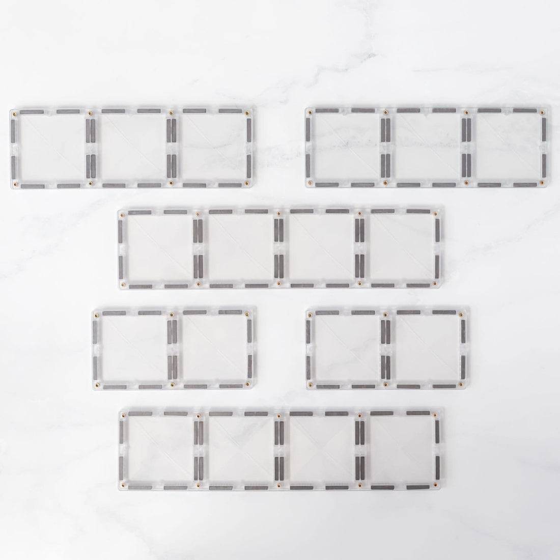 Caixa do Connetix Jogo blocos Magnético Clear Rectangle Pack 12 pc com ilustração de construção.