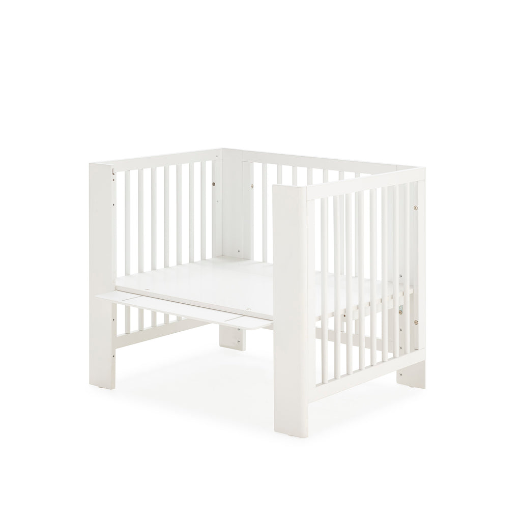 Converbaby Mini-berço 90x50 em configuração de mini-sofá com estrado elevado, vista lateral.