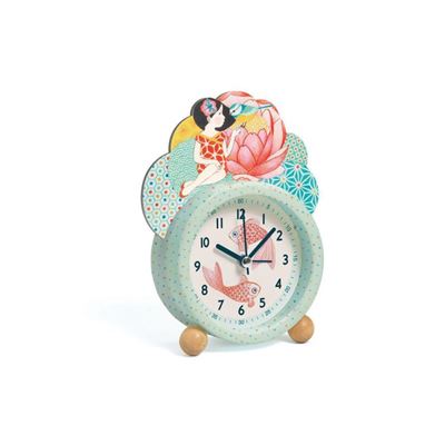Relógio despertador infantil Djeco Peixes, com mostrador verde-água e ilustração de peixes, encimado por uma menina e uma flor de lótus.