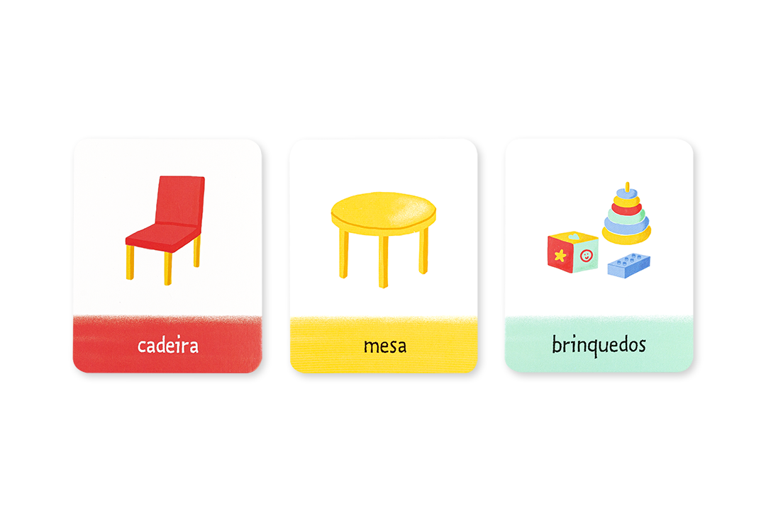 Três cartas dos Flashcards Casa com ilustrações de uma cadeira vermelha, mesa amarela e brinquedos.