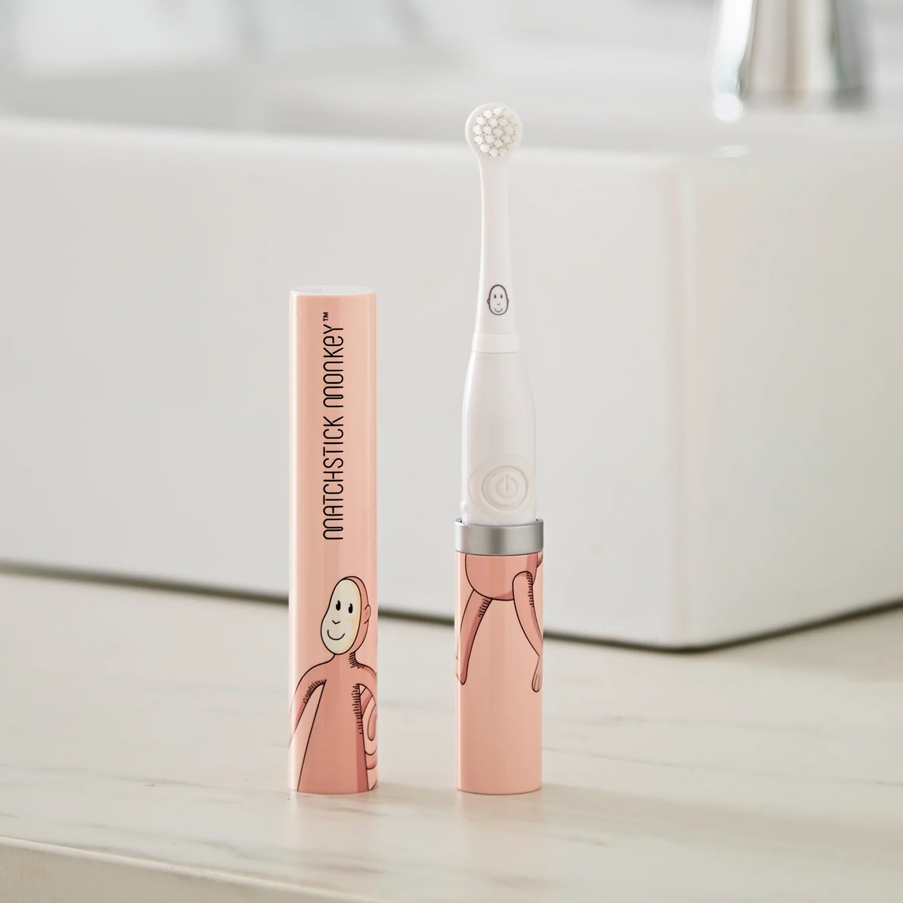 Escova de dentes elétrica Matchstick Monkey rosa fora da embalagem com tampa