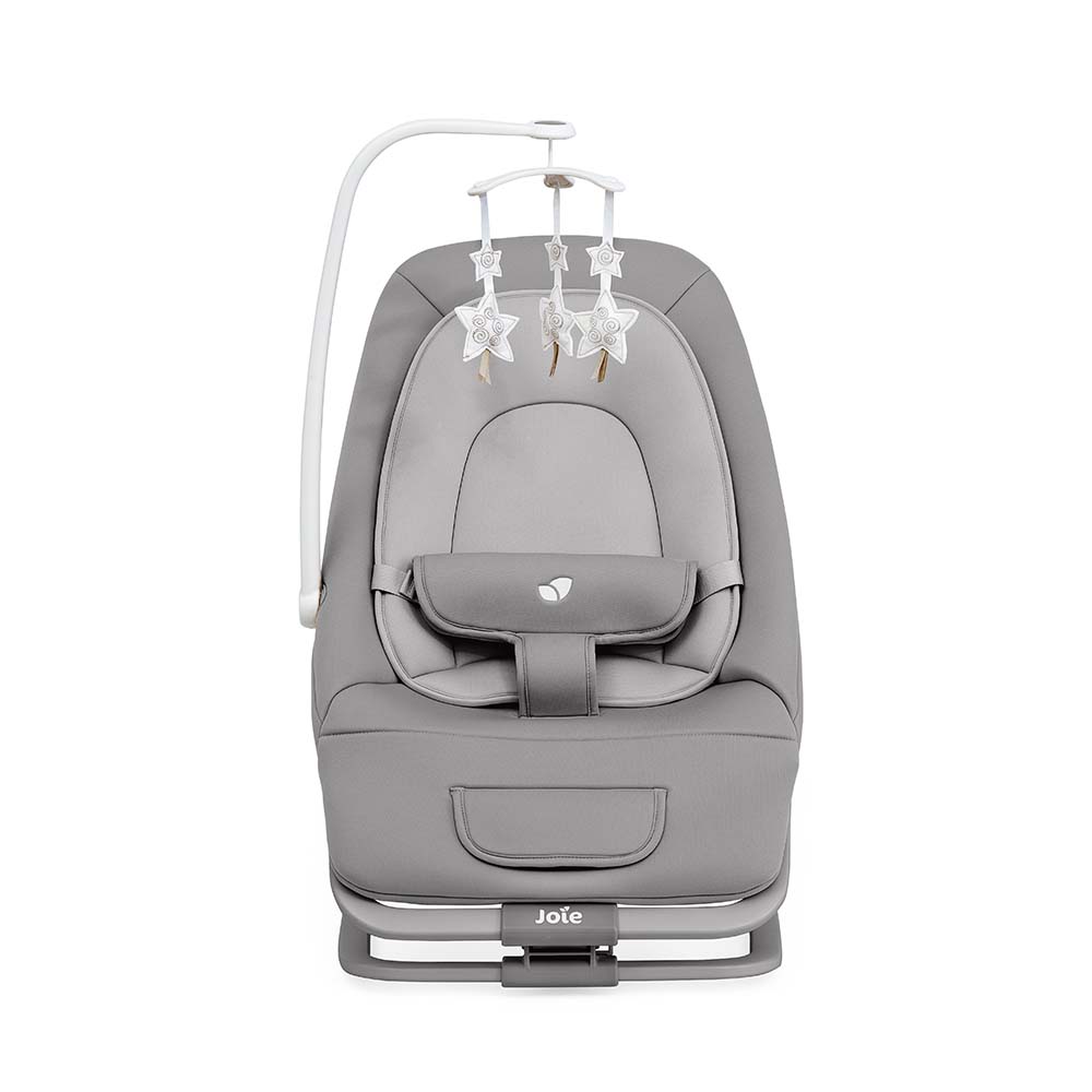 Detalhe do painel de controlo da espreguiçadeira Joie Dreamer, exibindo botões para vibração e seleção de melodias/sons da natureza.