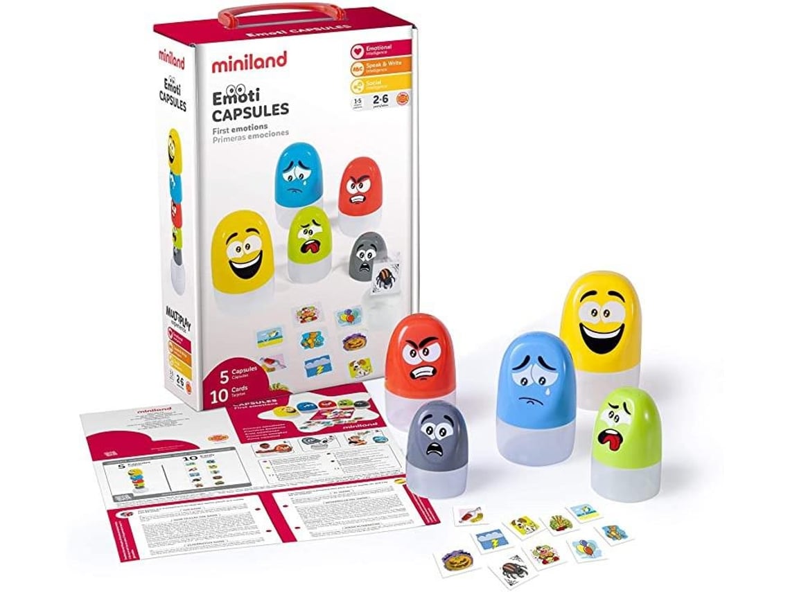 Miniland Jogo de Emoti Capsules, mostrando a caixa, as 5 cápsulas coloridas com expressões de emoções, 10 cartões e o folheto de instruções.