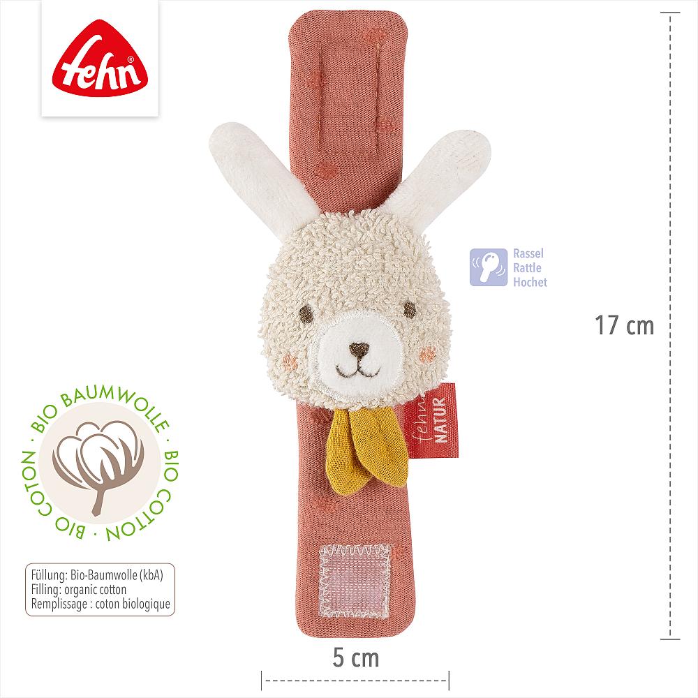 Dimensões da pulseira de atividades Fehn com guizo coelho: 17 cm de altura por 5 cm de largura, com ícones de chocalho e certificação de algodão orgânico (kbA).