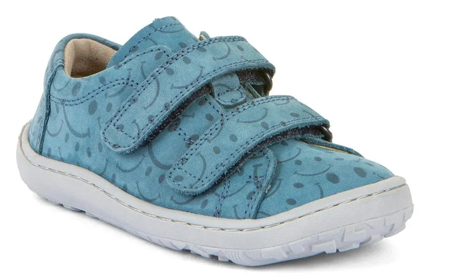 Sapatilha Froddo Barefoot infantil em couro azul-turquesa com padrão de 'smiles' e fecho de velcro duplo.