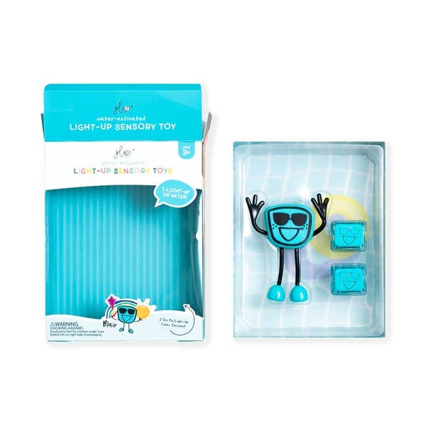 Embalagem aberta do GloPals Blair (azul) com o boneco e dois cubos de luz azuis em exposição.