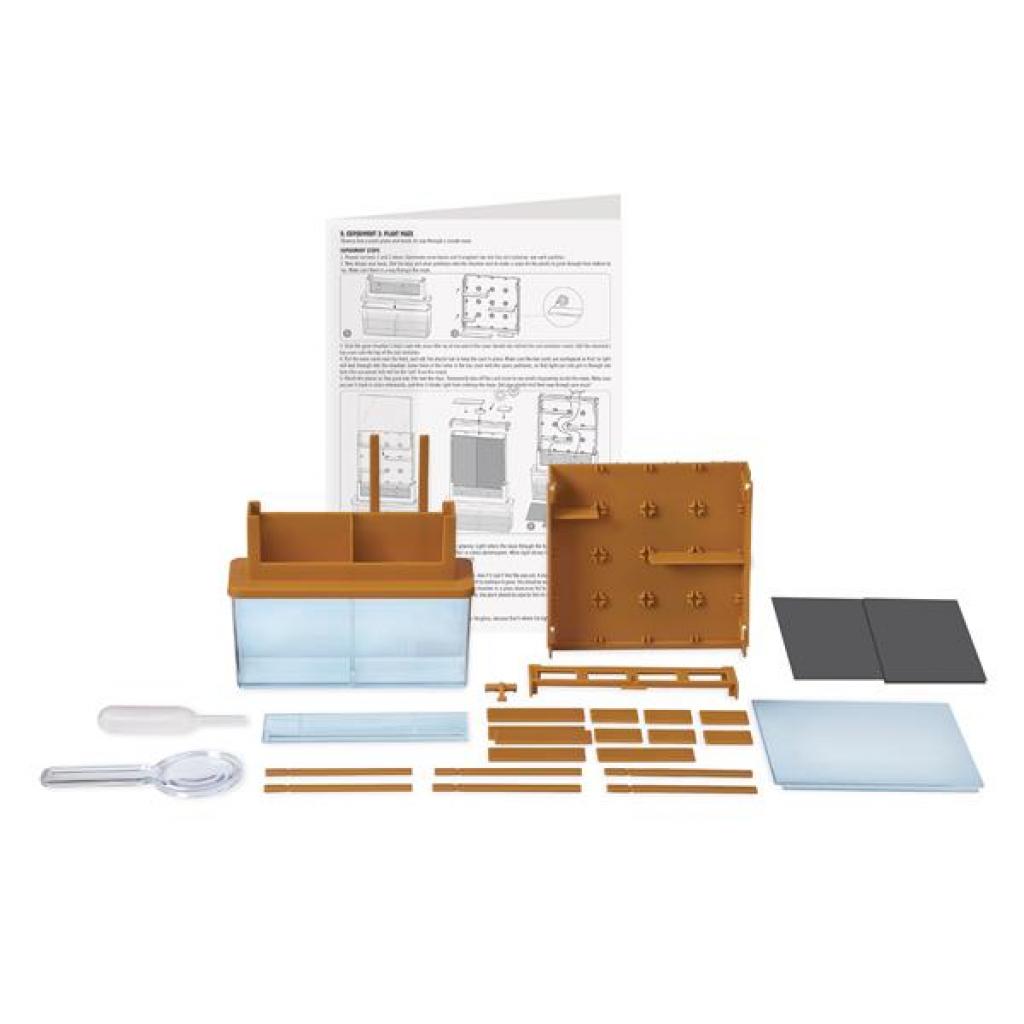 Componentes do kit GreenScience "Faz crescer as tuas plantas num labirinto" dispostos, incluindo divisórias, tampas, recipiente de terra e conta-gotas.