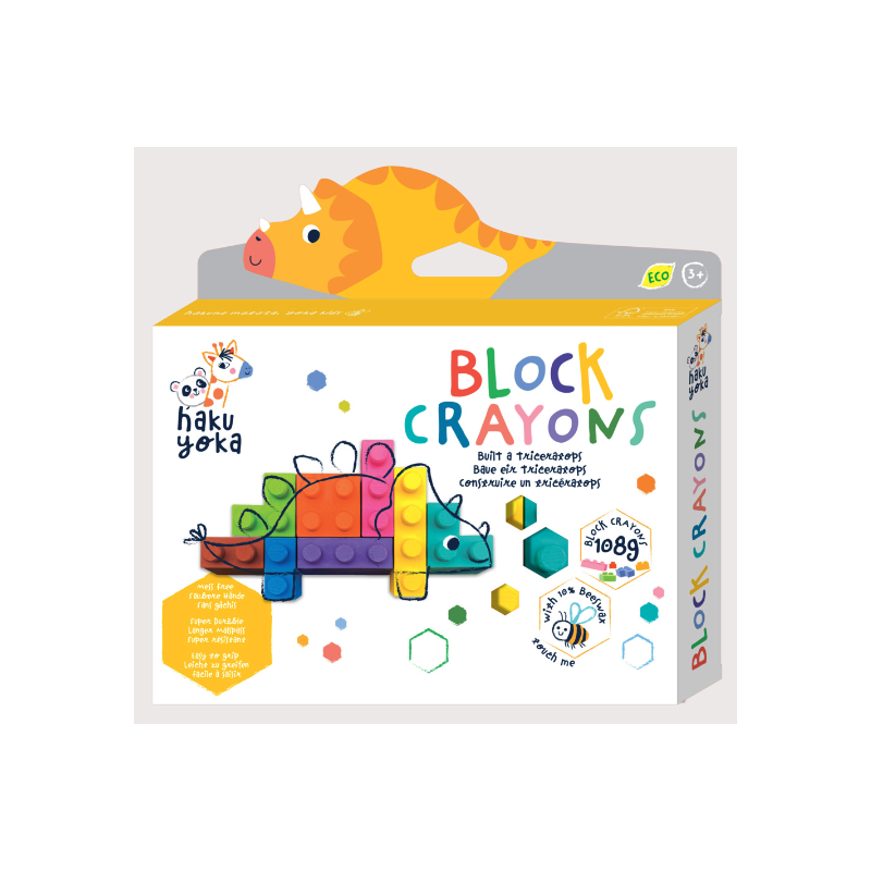 Embalagem dos lápis de cera em blocos HAKU YOKA com a forma de um triceratops colorido, destacando a composição em cera de abelha e a indicação de idade 3+.