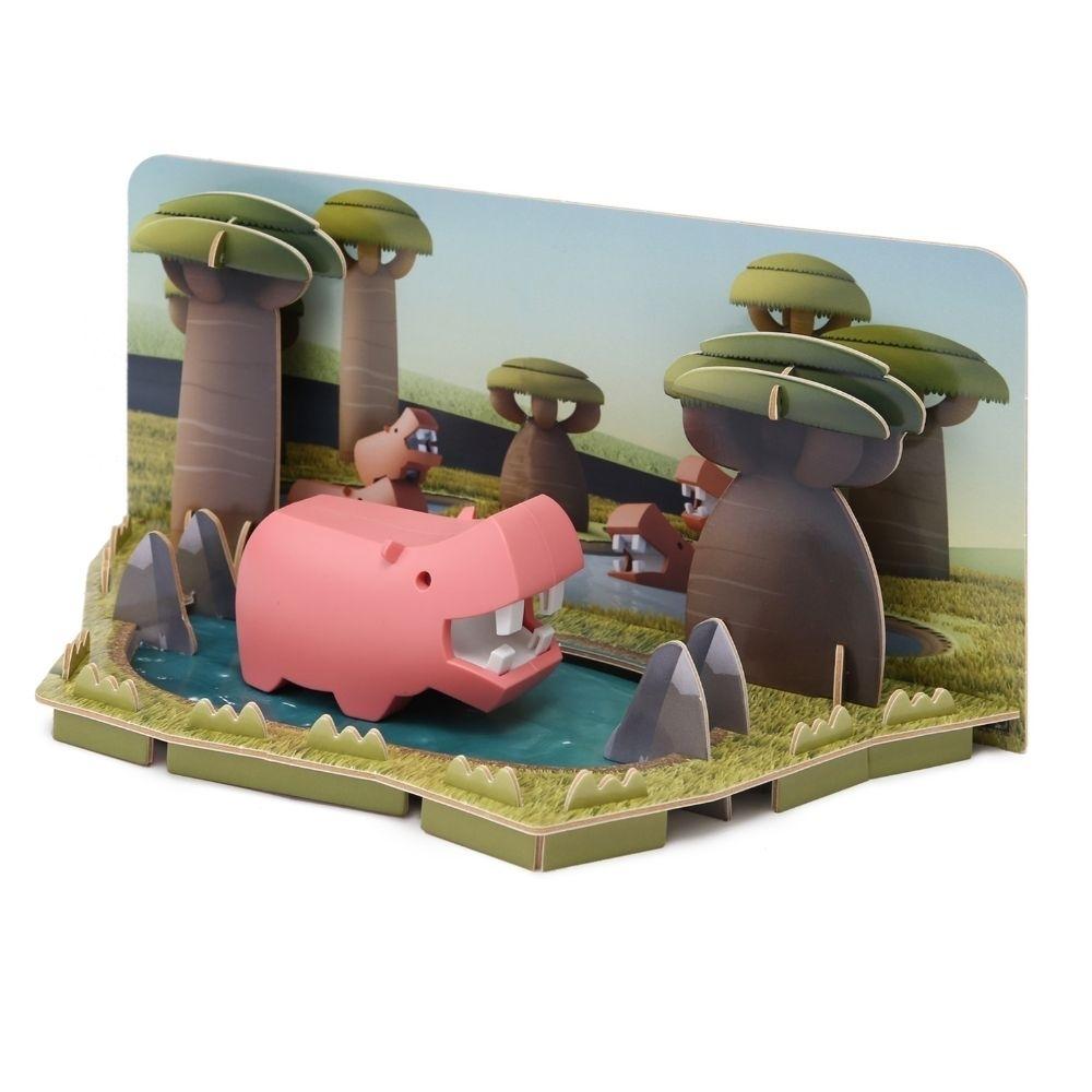 Halftoys Puzzle Diorama 3D Hipopótamo rosa no seu habitat de savana com lago e árvores.