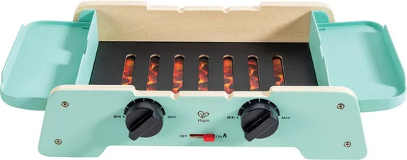 Base do grelhador de brincar Hape em madeira, com efeito de chamas realistas visíveis através das grelhas e botões de controlo.
