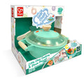 Caixa do brinquedo Hape Panela de Pressão, em tons de verde-água e branco, com destaque para a panela e a menção "Real Steam & Sound".