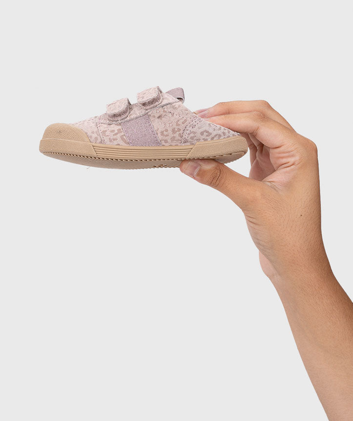 Mão a segurar uma sapatilha Igor Barefoot TENNIS LEO ROSA, mostrando o seu tamanho reduzido e a flexibilidade da sola.