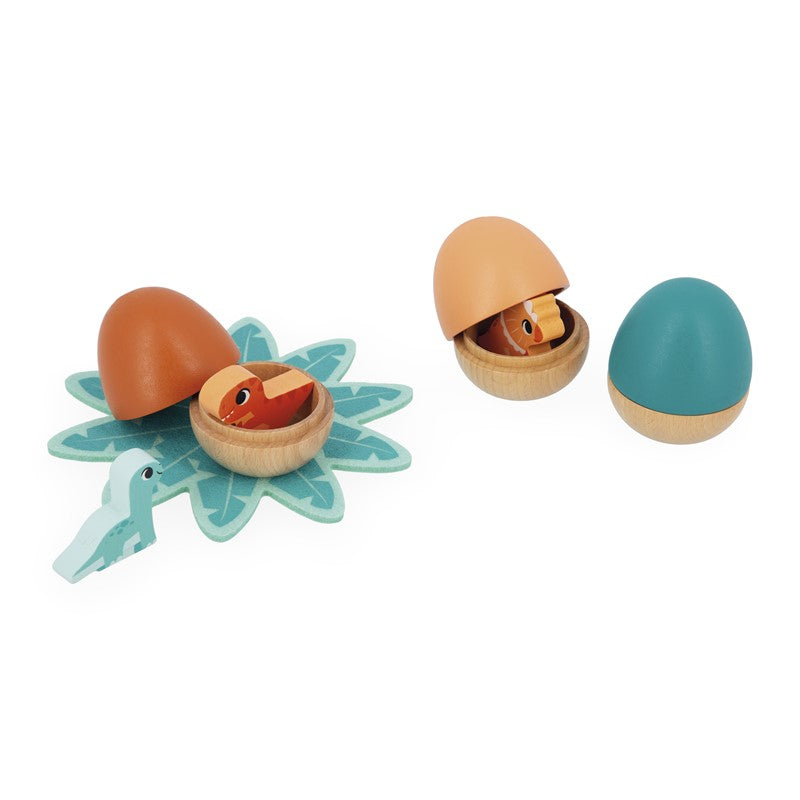 Ovos de dinossauro Janod abertos com dinossauros e base de feltro.
