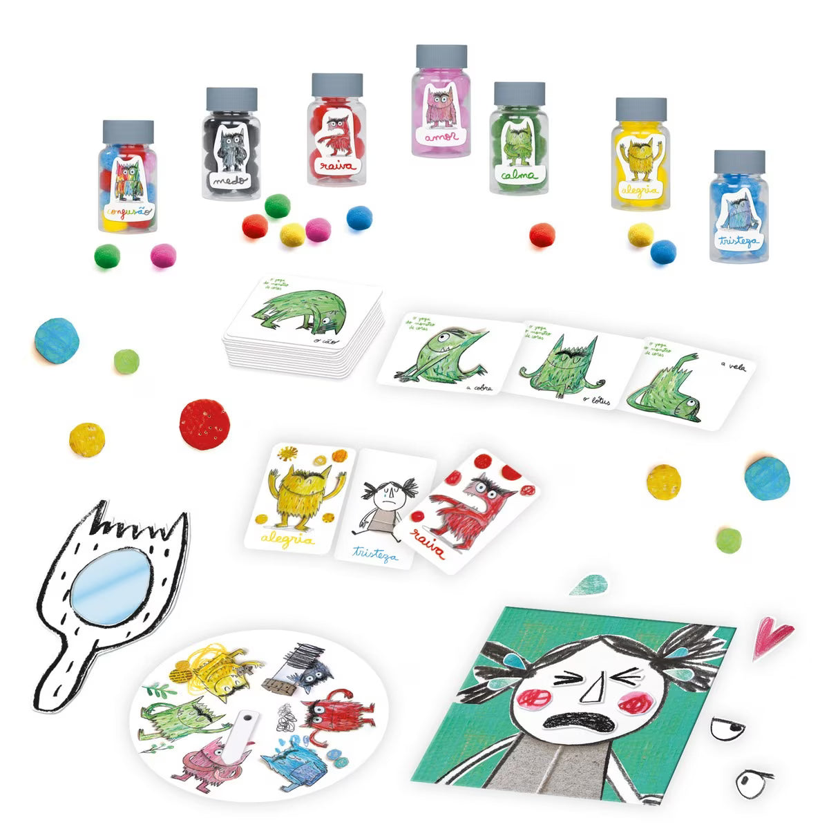 Detalhe dos componentes do jogo "Monstro das Cores" espalhados, mostrando os potes de emoções, bolas coloridas, cartas e o espelho de reconhecimento facial.